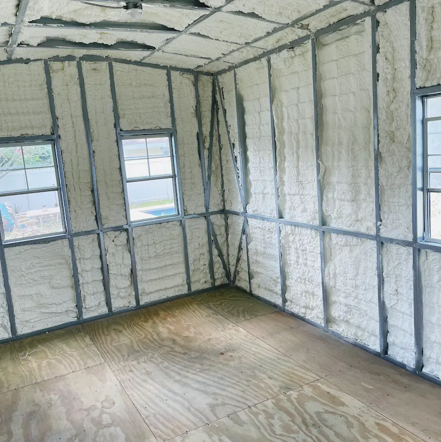 Closed-cell spray foam insulation applied to wall cavities in a residential project in Sappington